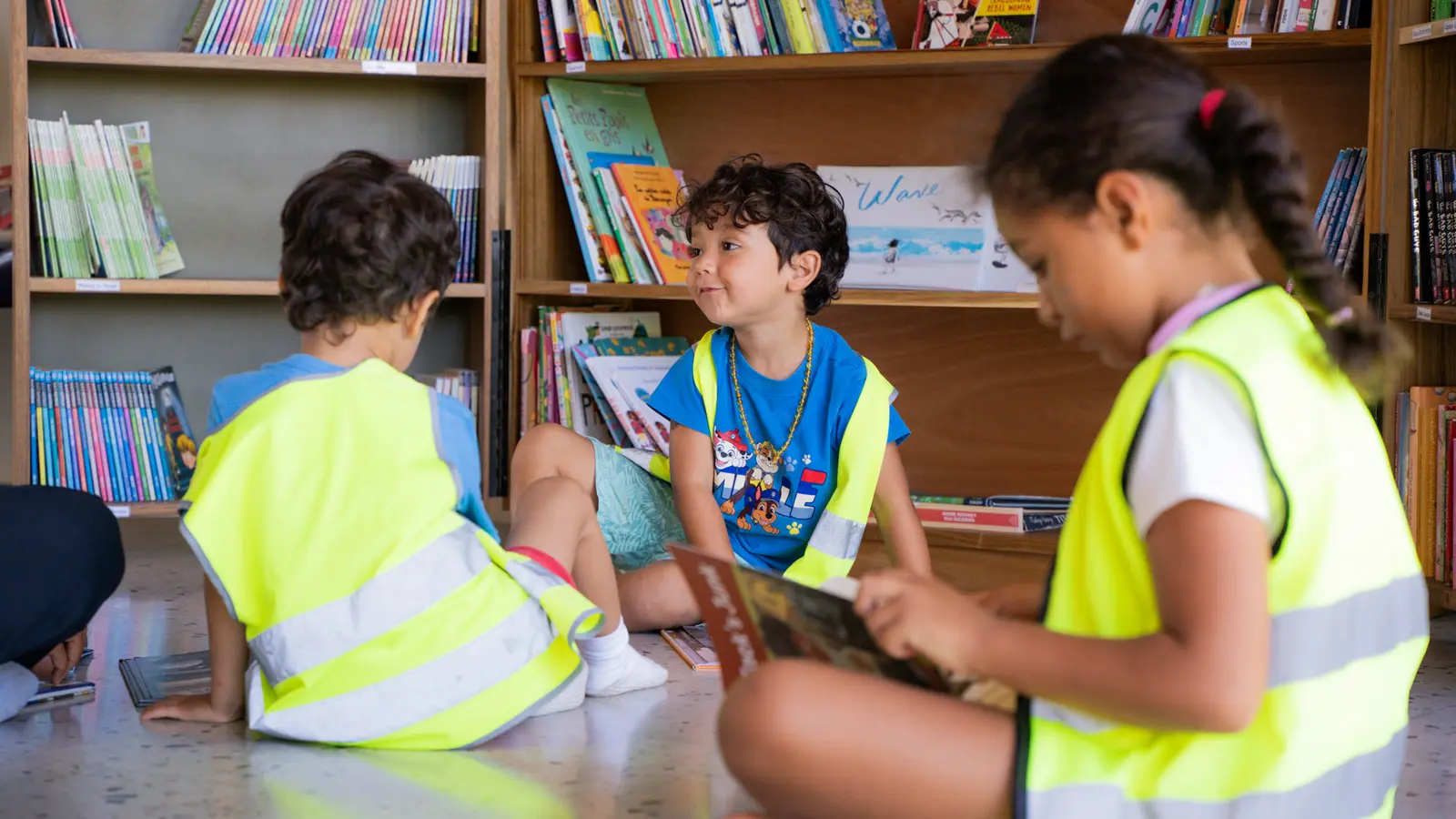 Young students reading together in the library